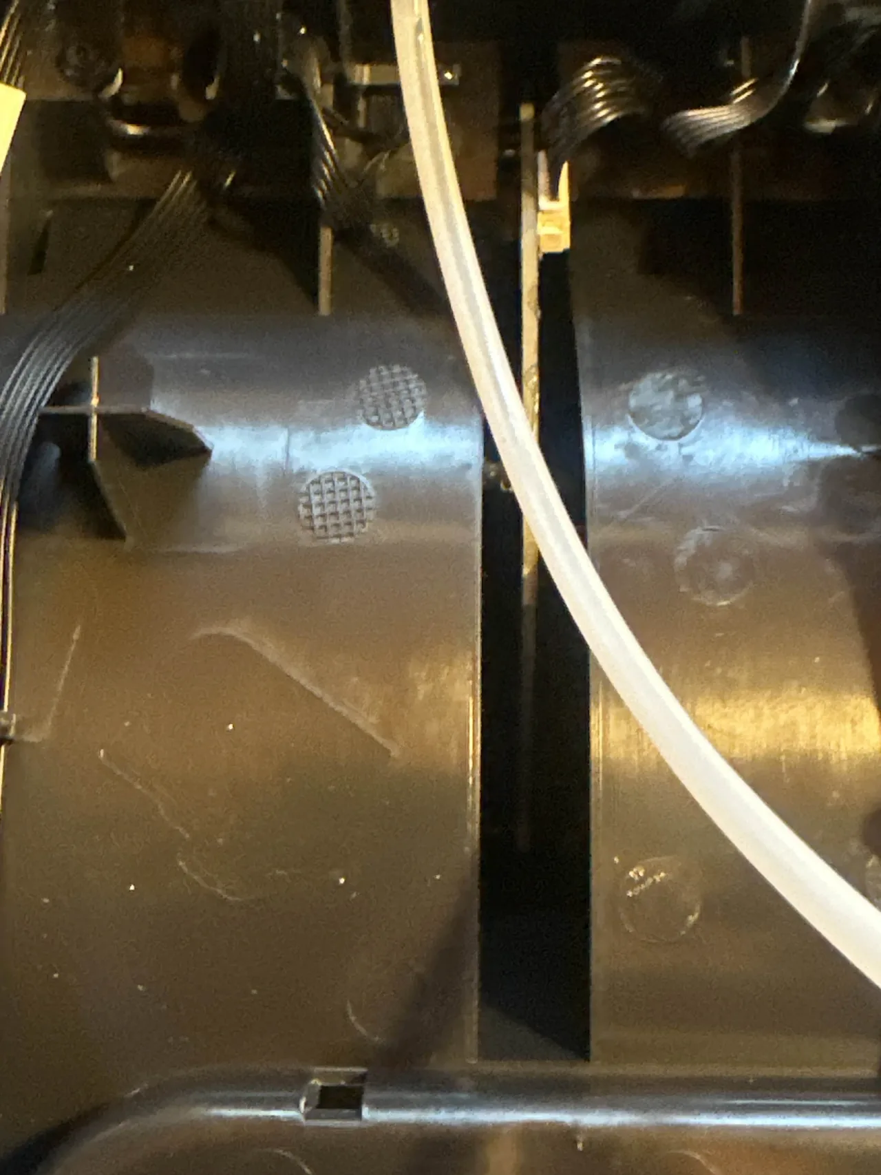 A Bambu Lab AMS PTFE tube with a visible wear line along its length, indicating a thinning inner wall that should be replaced