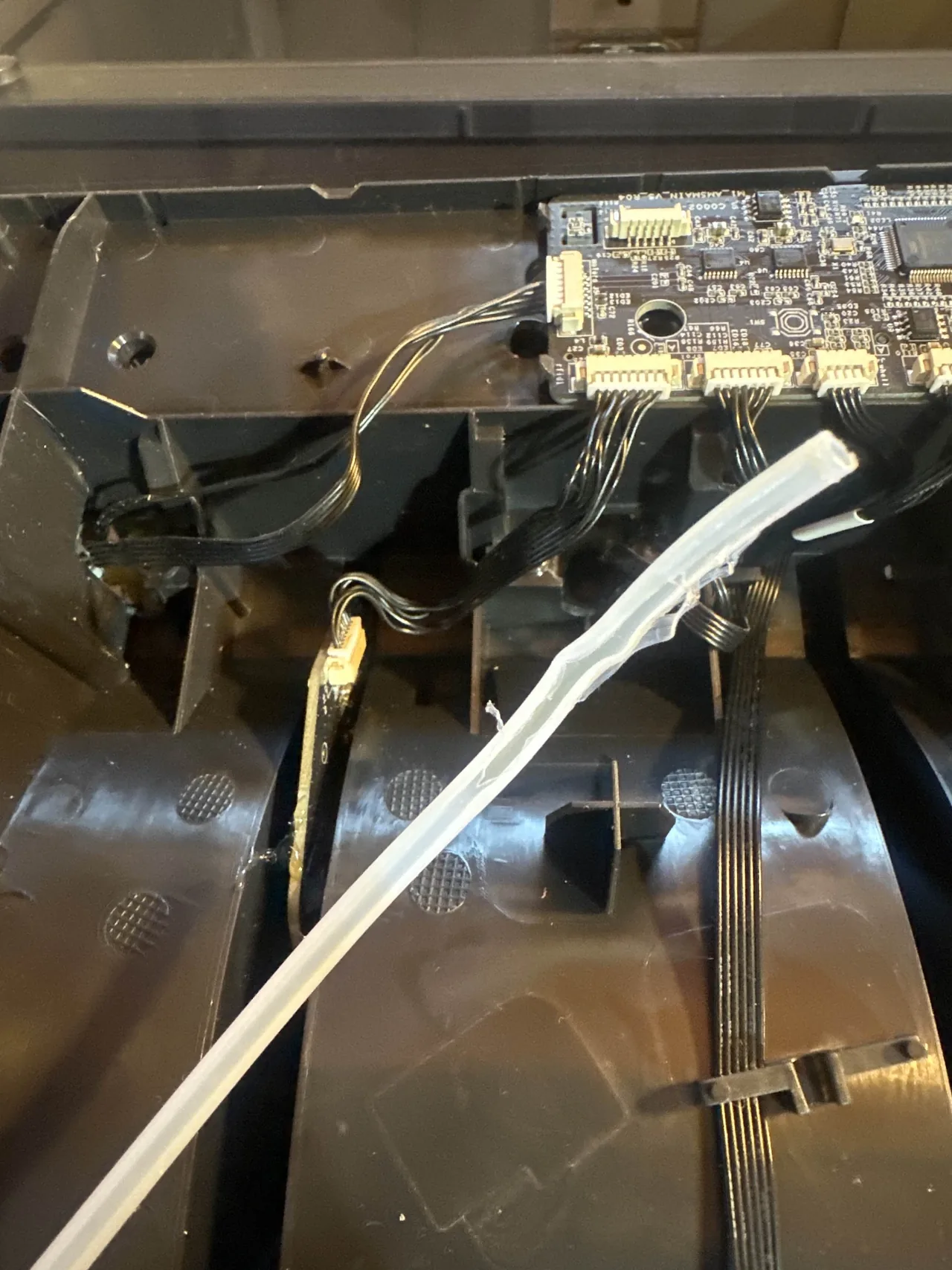A worn PTFE tube removed from a Bambu Lab AMS, frayed and split open at the easy end near catastrophic failure
